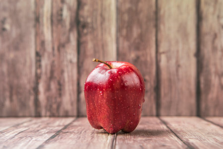 Red apple on weathered wooden backgroundの写真素材