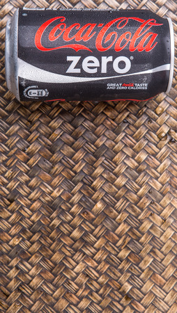PUTRAJAYA MALAYSIA  JUNE 28TH 2015. Coca Cola Zero on wicker background. Coca Cola drinks are produced and manufactured by The CocaCola Company an American multinational beverage corporation.のeditorial素材