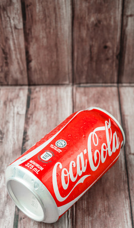PUTRAJAYA MALAYSIA  JUNE 28TH 2015. Coca Cola can on weathered wood. Coca Cola drinks are produced and manufactured by The CocaCola Company an American multinational beverage corporation.のeditorial素材