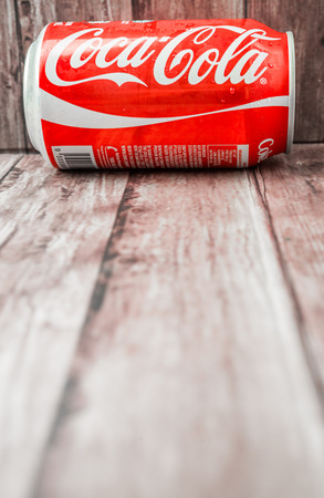 PUTRAJAYA MALAYSIA  JUNE 28TH 2015. Coca Cola can on weathered wood. Coca Cola drinks are produced and manufactured by The CocaCola Company an American multinational beverage corporation.のeditorial素材