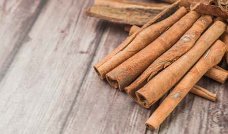 Cinnamon sticks spice over weathered wooden backgroundの写真素材