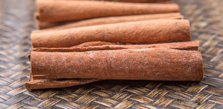 Cinnamon sticks spice over wicker background