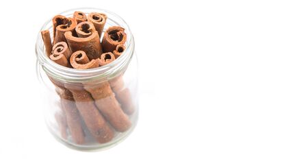 Cinnamon sticks spice in a mason jar over white backgroundの写真素材