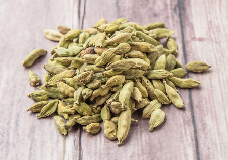 Cardamom spice over weathered wood backgroundの写真素材