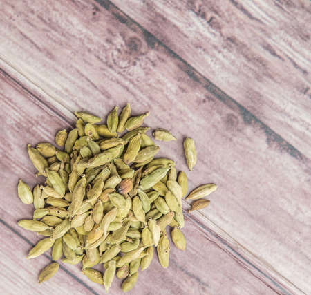 Cardamom spice over weathered wood backgroundの写真素材