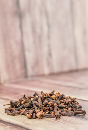 Clove spices over weathered wooden backgroundの写真素材