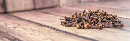 Clove spices over weathered wooden backgroundの写真素材
