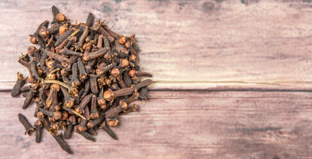 Clove spices over weathered wooden backgroundの写真素材