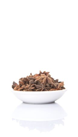Star anise spices in white bowl over white backgroundの写真素材