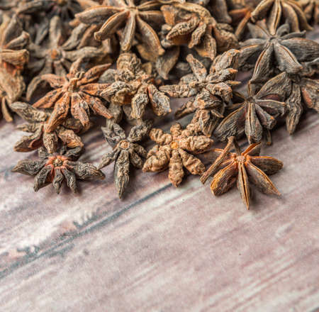Star anise spices over weathered wooden backgroundの写真素材