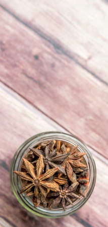Star anise spice in a mason jar over weathered backgroundの写真素材