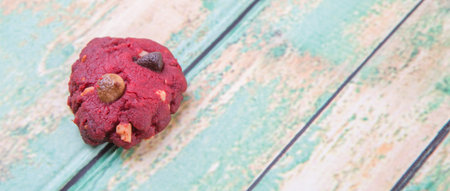 Homemade red velvet flavor cookie over weathered light green colored wooden background