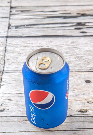 PUTRAJAYA, MALAYSIA - JULY 5TH, 2015. Pepsi can on weathered wood. Pepsi is a carbonated soft drink...