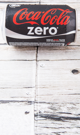 PUTRAJAYA, MALAYSIA - JULY 5TH, 2015. Coca Cola Zero on weathered wood. Coca Cola drinks are produced and manufactured by The Coca-Cola Company, an American multinational beverage corporation.のeditorial素材