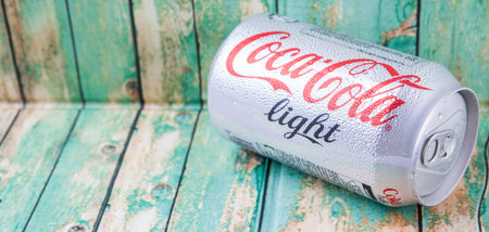 PUTRAJAYA, MALAYSIA - JULY 5TH, 2015. Coca Cola Light on weathered wood. Coca Cola drinks are...