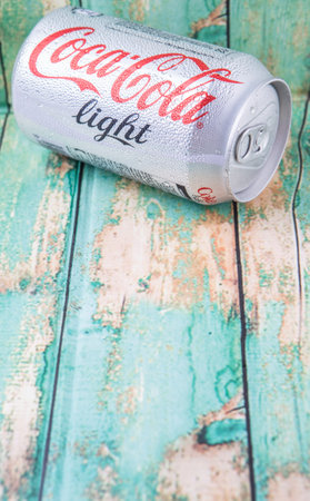 PUTRAJAYA, MALAYSIA - JULY 5TH, 2015. Coca Cola Light on weathered wood. Coca Cola drinks are...