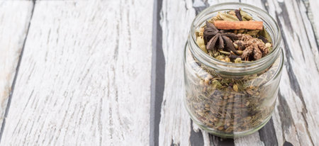 Mix herbs and spices in mason jar over weathered wooden backgroundの写真素材