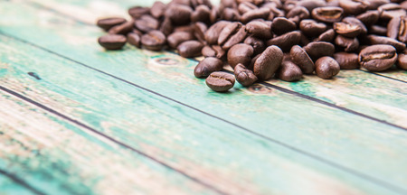 Roasted coffee beans over rustic wooden backgroundの写真素材