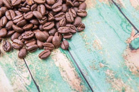 Roasted coffee beans over rustic wooden backgroundの写真素材