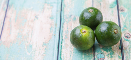 Calamansi citrus over weathered wooden backgroundの写真素材
