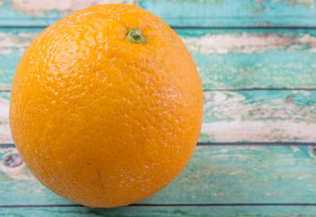 Orange fruit over weathered wooden backgroundの写真素材