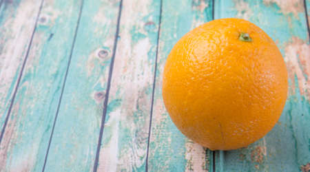 Orange fruit over weathered wooden backgroundの写真素材