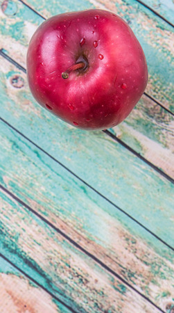 Red apple fruit over weathered wooden backgroundの写真素材