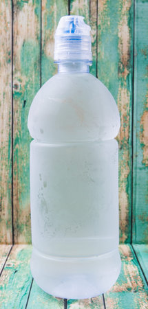 A bottle of mineral water over wooden background