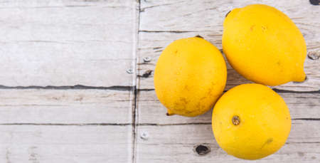 Lemon fruits over rustic wooden backgroundの写真素材