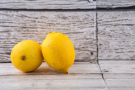Lemon fruits over rustic wooden backgroundの写真素材