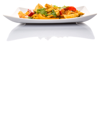 Malaysian traditional dish of Ayam Paprik or spicy stir fry chicken on white plate over white backgroundの写真素材