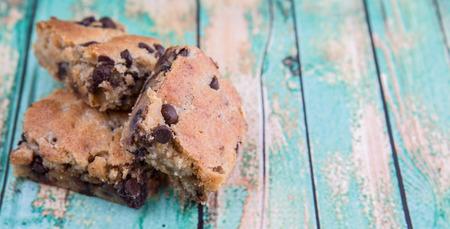 Sweet brownie dessert bar with chocolate chips over wooden backgroundの写真素材