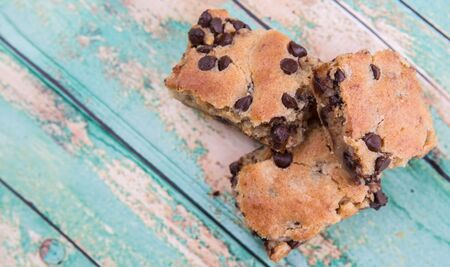 Sweet brownie dessert bar with chocolate chips over wooden backgroundの写真素材