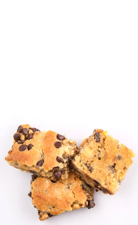 Sweet brownie dessert bar with chocolate chips over white background