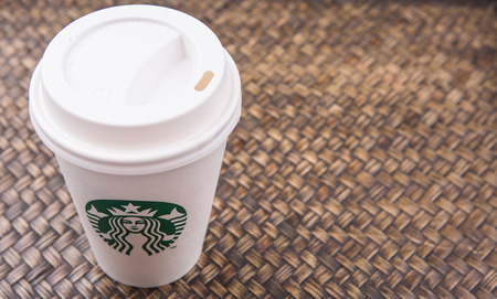 PUTRAJAYA, MALAYSIA - JULY 20TH, 2015. Starbucks coffee over wicker background. Founded in 1971, Starbucks is the largest coffeehouse company in the world.のeditorial素材