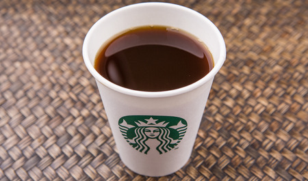 PUTRAJAYA, MALAYSIA - JULY 20TH, 2015. Starbucks coffee over wicker background. Founded in 1971, Starbucks is the largest coffeehouse company in the world.のeditorial素材