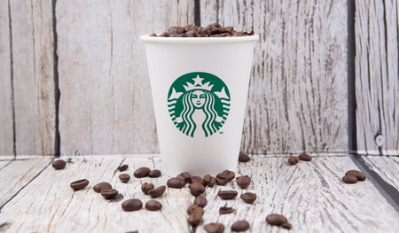 PUTRAJAYA, MALAYSIA - JULY 20TH, Coffee beans in Starbucks paper cup. Founded in 1971, Starbucks is the largest coffeehouse company in the world.のeditorial素材