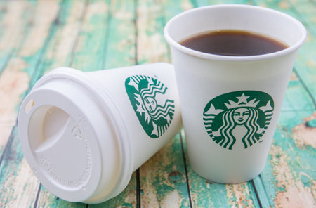 PUTRAJAYA, MALAYSIA - JULY 20TH, 2015. Starbuck coffee over wooden background. Founded in 1971,...