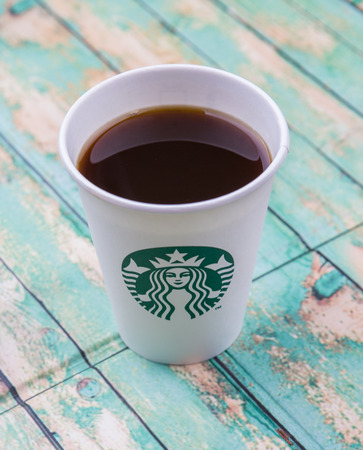 PUTRAJAYA, MALAYSIA - JULY 20TH, 2015. Starbuck coffee over wooden background. Founded in 1971, Starbucks is the largest coffeehouse company in the world.のeditorial素材