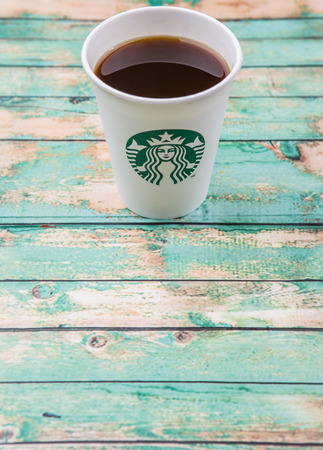 PUTRAJAYA, MALAYSIA - JULY 20TH, 2015. Starbuck coffee over wooden background. Founded in 1971, Starbucks is the largest coffeehouse company in the world.のeditorial素材