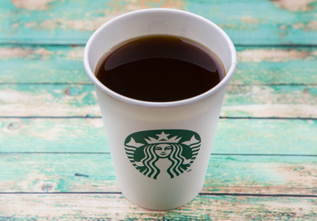 PUTRAJAYA, MALAYSIA - JULY 20TH, 2015. Starbuck coffee over wooden background. Founded in 1971, Starbucks is the largest coffeehouse company in the world.のeditorial素材