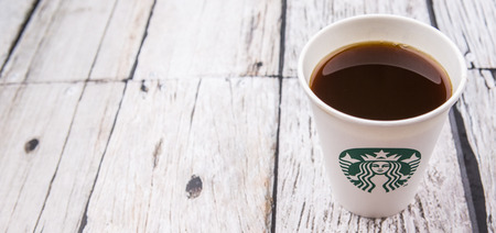 PUTRAJAYA, MALAYSIA - JULY 20TH, 2015. Starbuck coffee over wooden background. Founded in 1971, Starbucks is the largest coffeehouse company in the world.のeditorial素材