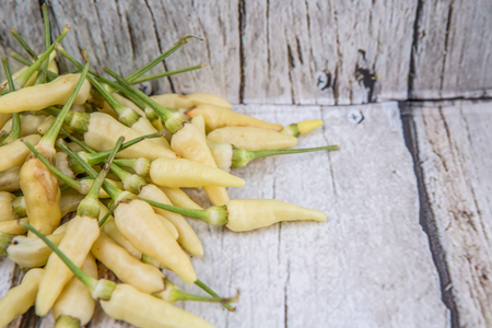 Thai chili or bird\'s eye chilies over wooden backgroundの写真素材