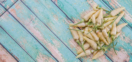 Thai chili or bird\'s eye chilies over wooden backgroundの写真素材