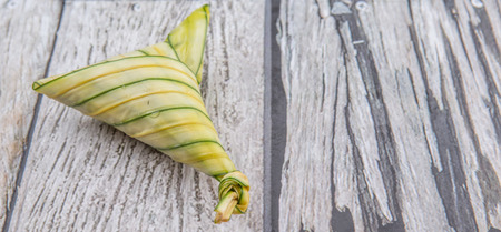 Malay dish ketupat daun palas or rice dumpling where glutinous rice is wrapped in a triangular shape using the leaves of the fan palmの写真素材