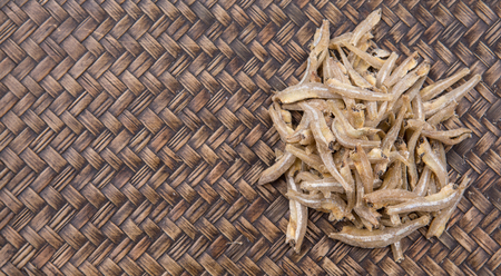 Raw anchovies in over rustic wicker backgroundの写真素材
