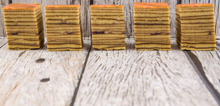 Malaysian dish Kek Lapis Sarawak or Sarawak layered cake over wooden backgroundの写真素材