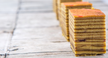 Malaysian dish Kek Lapis Sarawak or Sarawak layered cake over wooden backgroundの写真素材