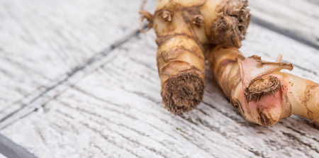 Galangal or Lengkuas roots over wooden backgroundの写真素材