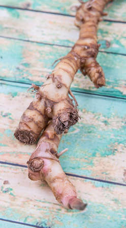Galangal or Lengkuas roots over wooden backgroundの写真素材